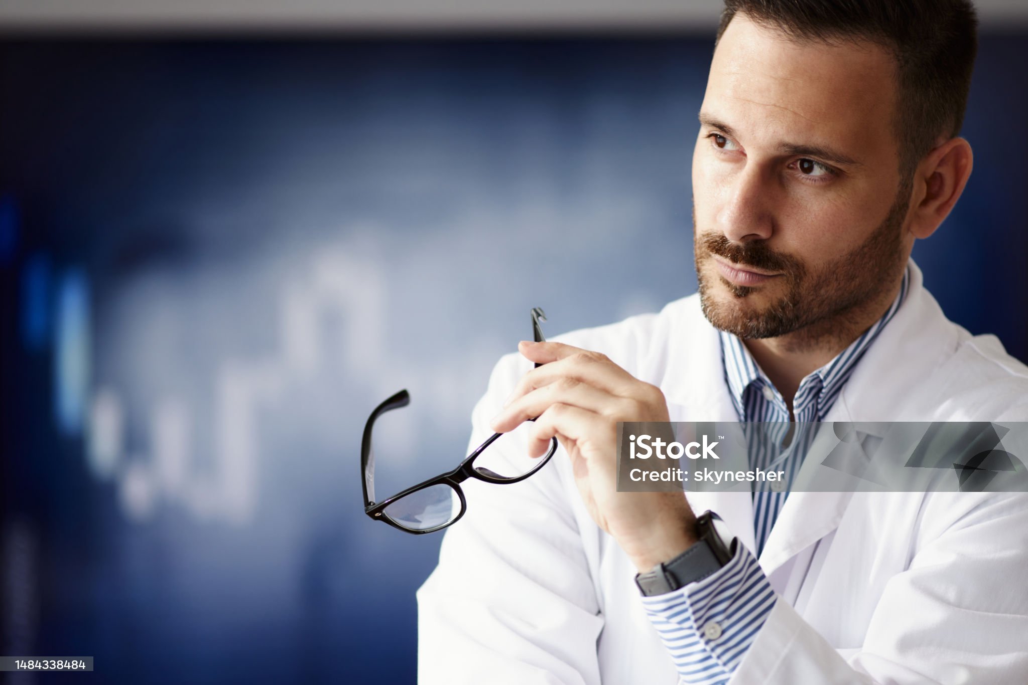 Portrait of pensive male doctor in hospital. Copy space.